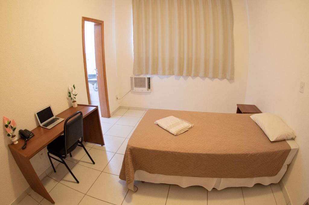 Postel nebo postele na pokoji v ubytování Getúllio Hotel
