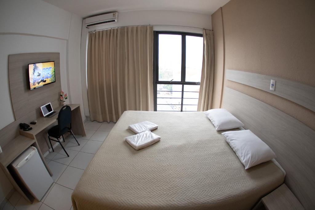 Postel nebo postele na pokoji v ubytování Getúllio Hotel