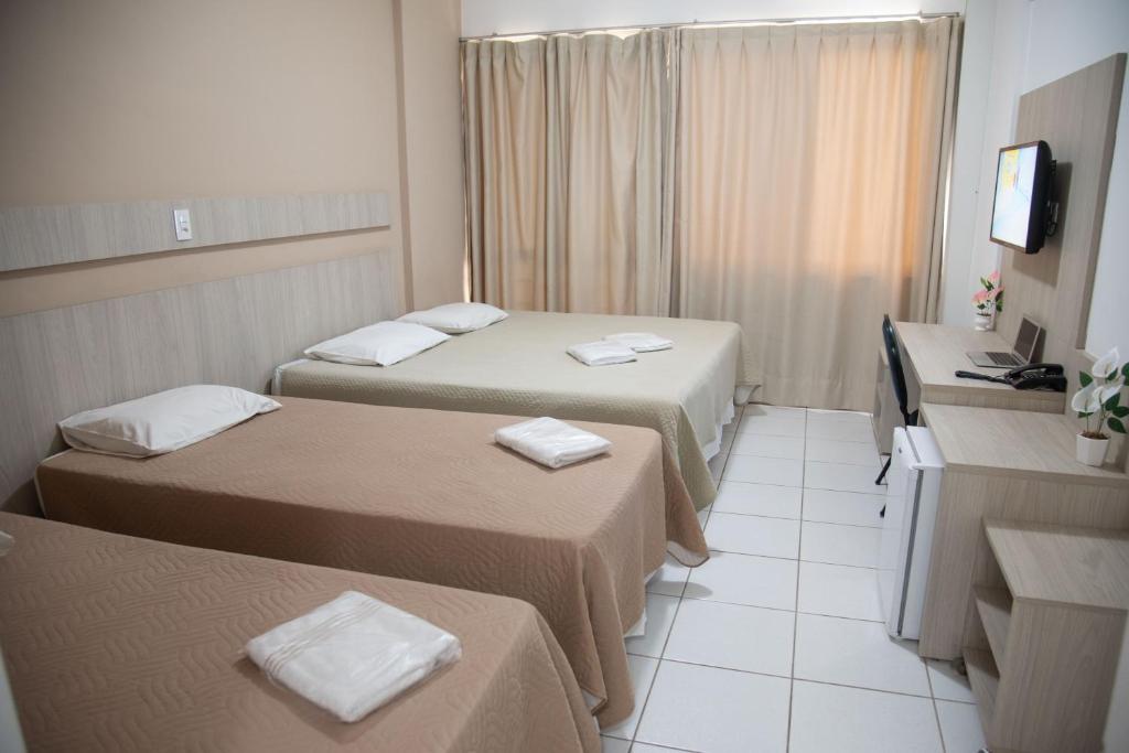 Postel nebo postele na pokoji v ubytování Getúllio Hotel