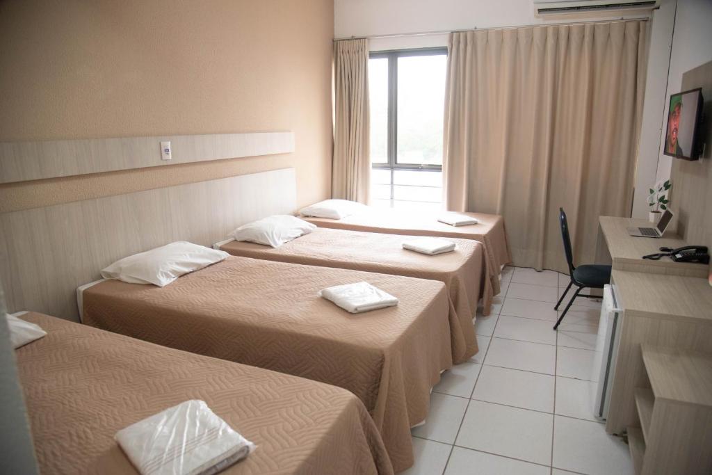 Postel nebo postele na pokoji v ubytování Getúllio Hotel