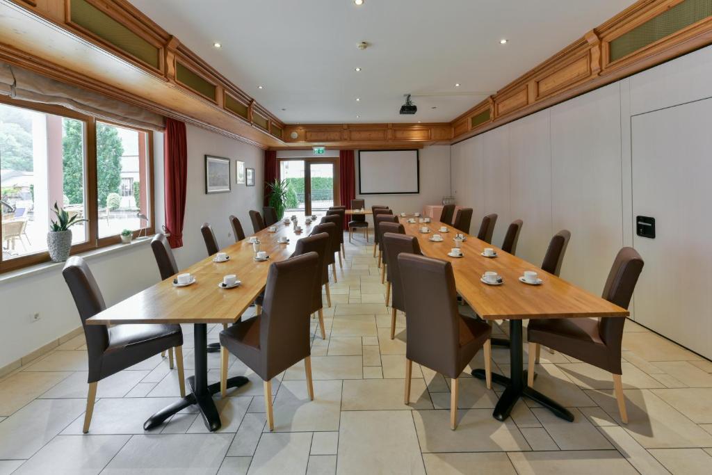 a large conference room with wooden tables and chairs at Hotel Belle Vue in Vianden