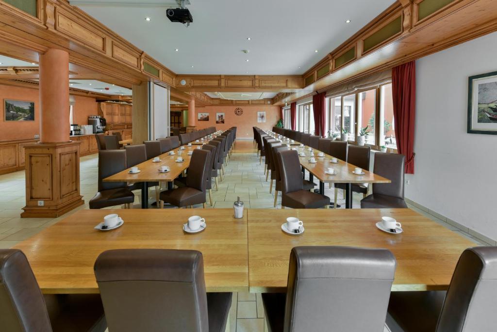 a large conference room with wooden tables and chairs at Hotel Belle Vue in Vianden