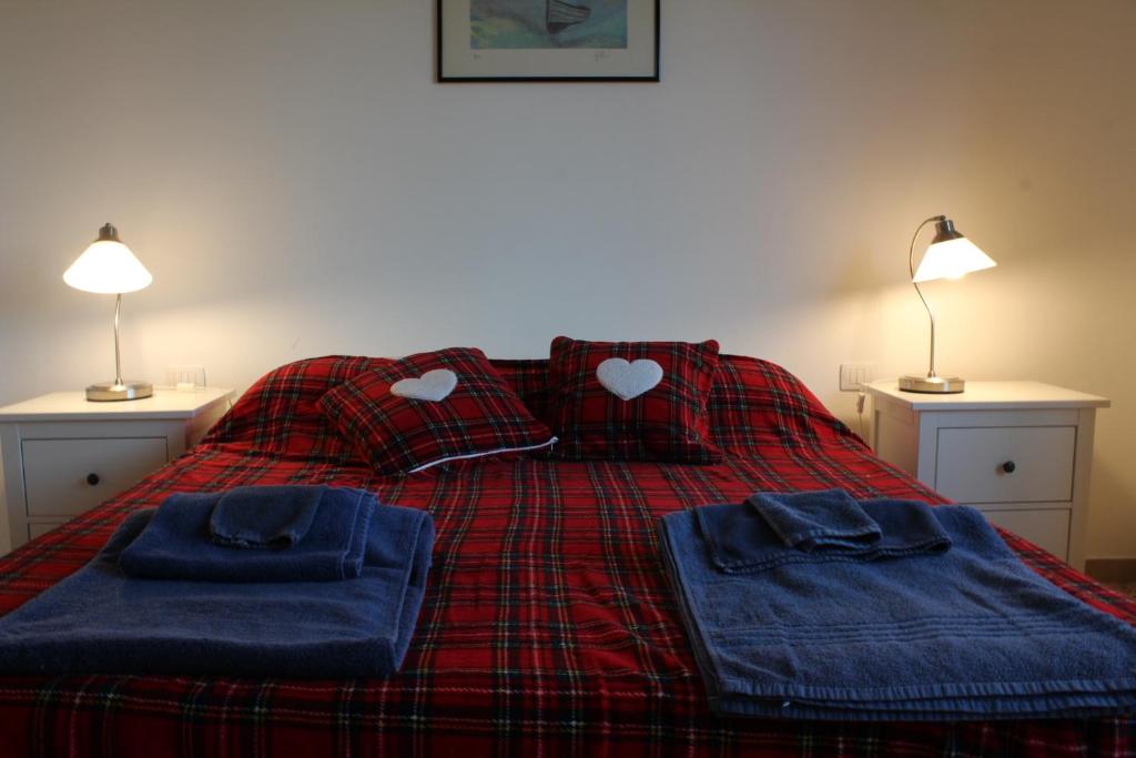 a bed with two pillows and blue towels on it at Vado al cento in Ancona