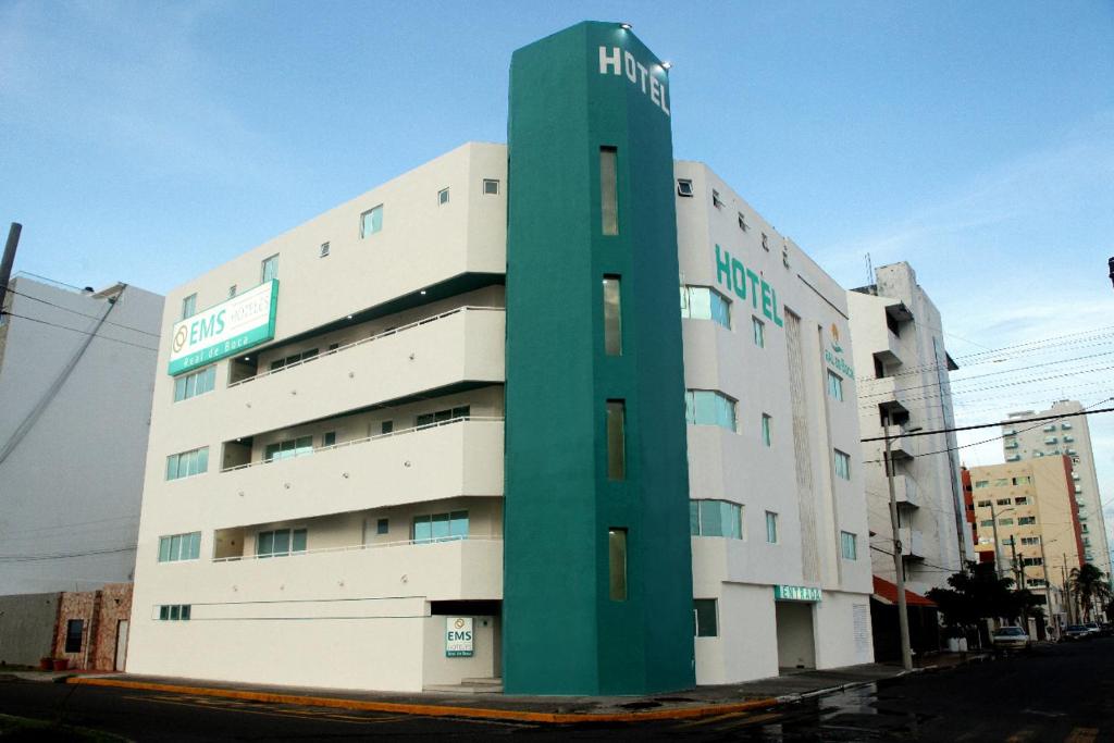 un gran edificio blanco con una torre verde en EMS Hoteles Boca del Río, en Veracruz