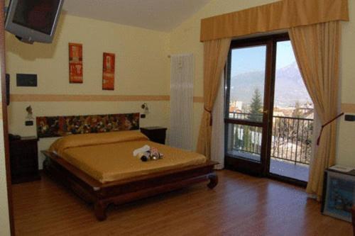 a bedroom with a bed and a sliding glass door at Soggiorno Boccuti in Montella