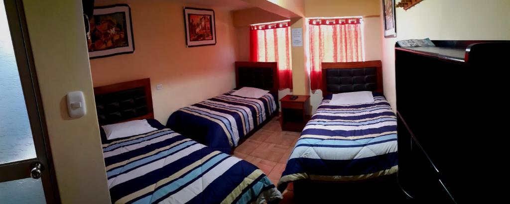 Postel nebo postele na pokoji v ubytování Hostal kuntur cusco