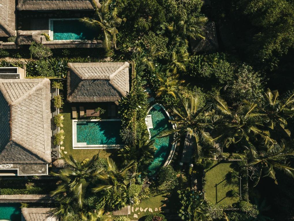 an aerial view of a resort with palm trees and a swimming pool at Ubud Nyuh Bali Resort & Spa in Ubud