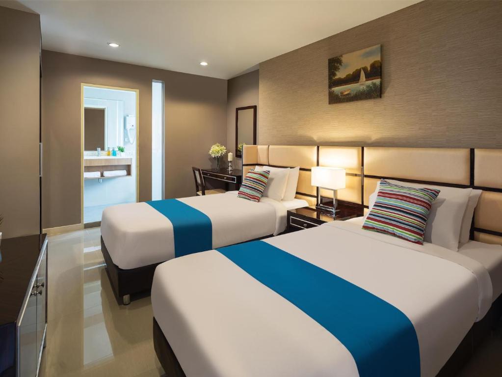 Кровать или кровати в номере Ton Aor Place Hotel