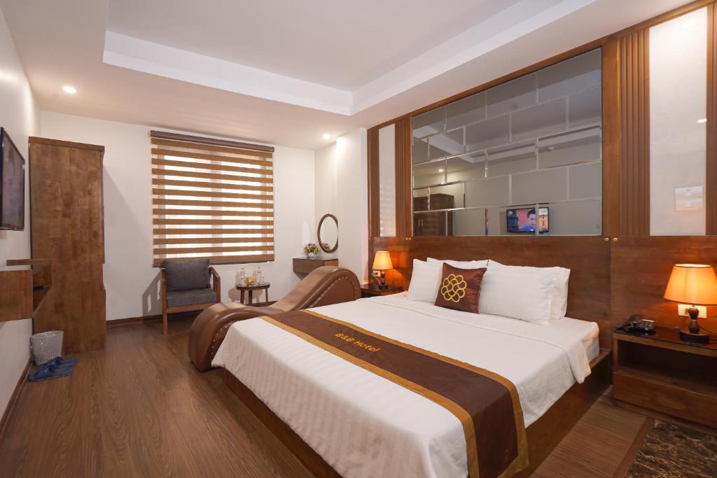a bedroom with a large bed and a window at B & B Hotel Quan Hoa in Hanoi