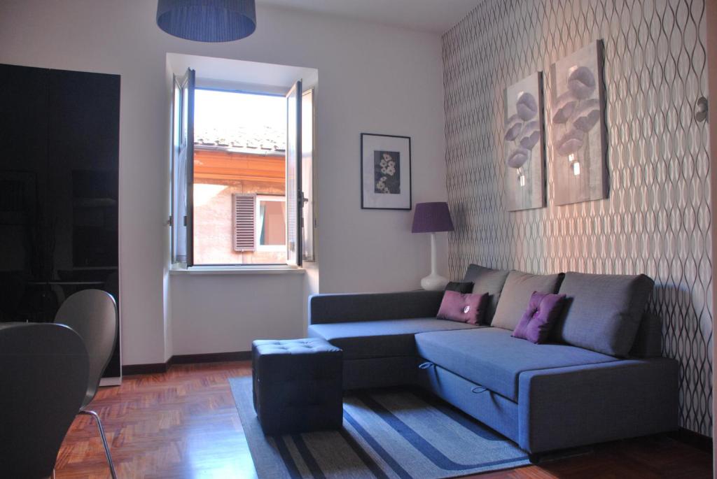 a living room with a couch and a window at Leila's Apartment in Rome