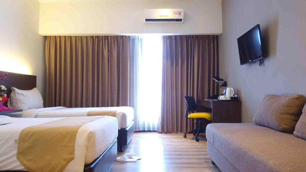 Postel nebo postele na pokoji v ubytování Yunna Hotel Lampung