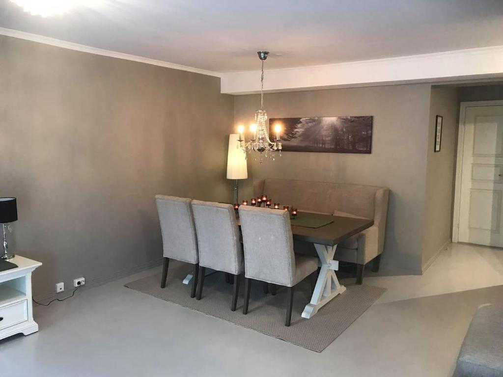 a dining room with a table and chairs at Notodden Sentrum Apartment NO 2 in Notodden