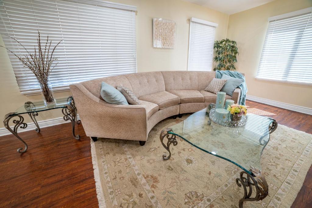 a living room with a couch and a glass table at Your Home in LA in Los Angeles