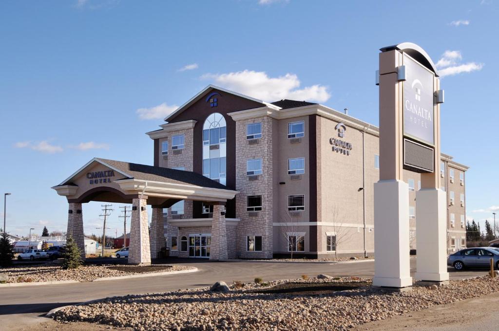 a large building with a sign in front of it at Canalta Hotel Melfort in Melfort