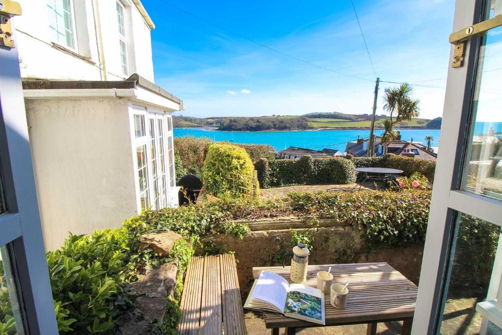 a view of the water from the balcony of a house at Chapel Cottage in Saint Mawes