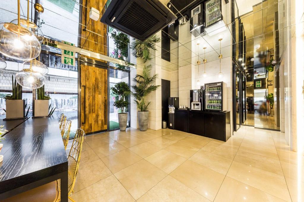 a lobby of a store with tables and chairs at Forestar Hotel Sinchon in Seoul