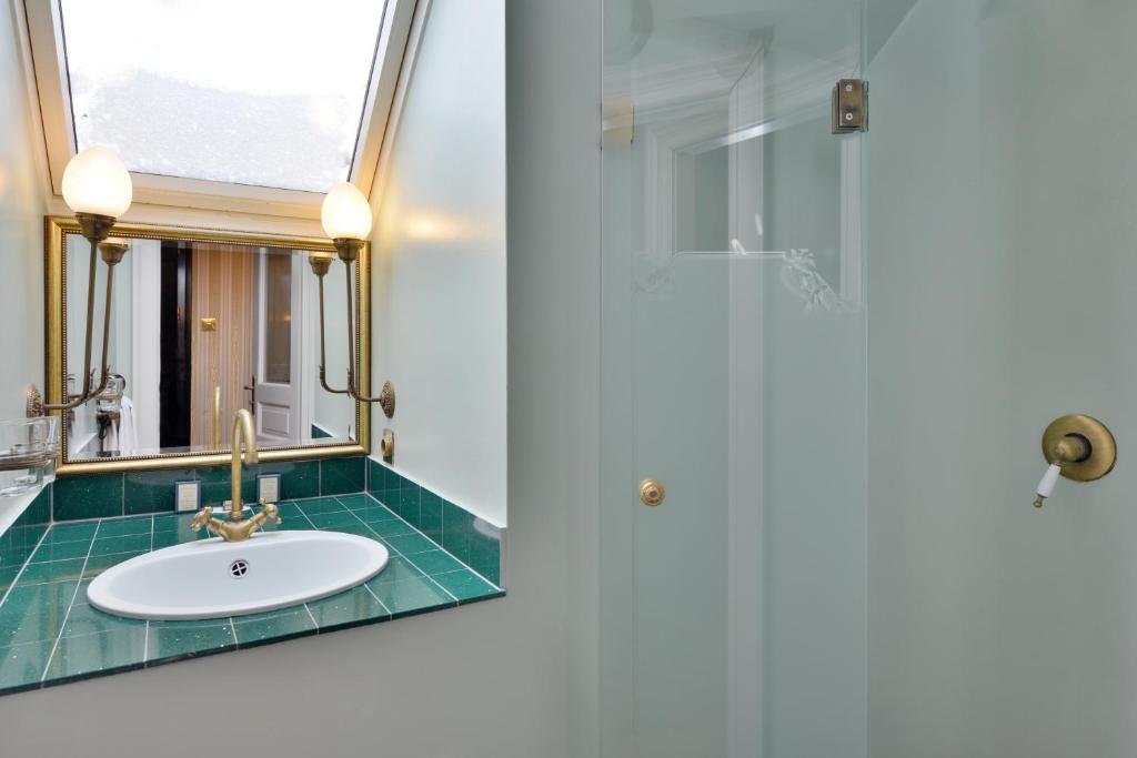 a bathroom with a sink and a mirror at Gerlóczy Boutique Hotel in Budapest