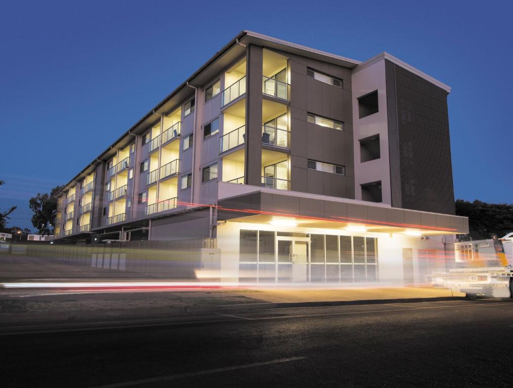 a large building with a parking meter in front of it at Oaks Moranbah Suites in Moranbah