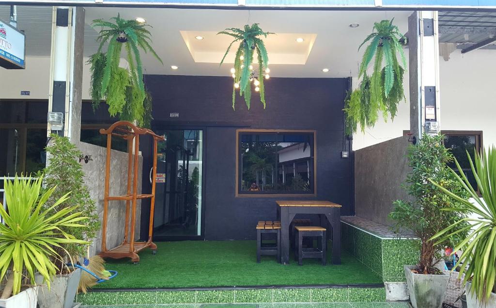 a front porch of a house with a table and some plants at I-Talay Garden in Ko Samed