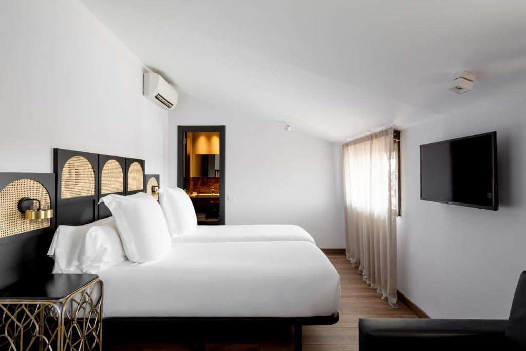 Postel nebo postele na pokoji v ubytování Hotel Astoria