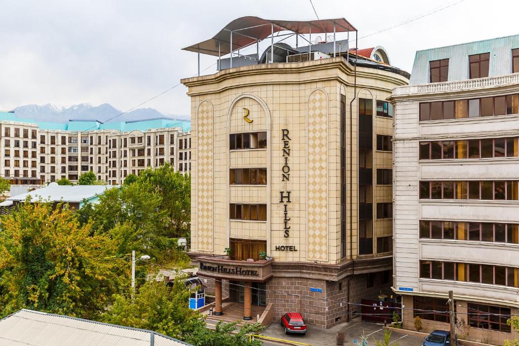 a building with a clock tower on top of it at Renion Hills Hotel in Almaty