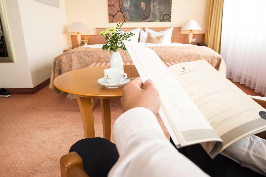 Postel nebo postele na pokoji v ubytování Carathotel Basel/Weil am Rhein