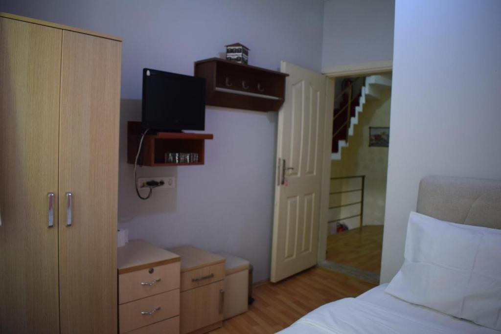 a bedroom with a bed and a tv on the wall at Sur Istanbul Hotel in Istanbul