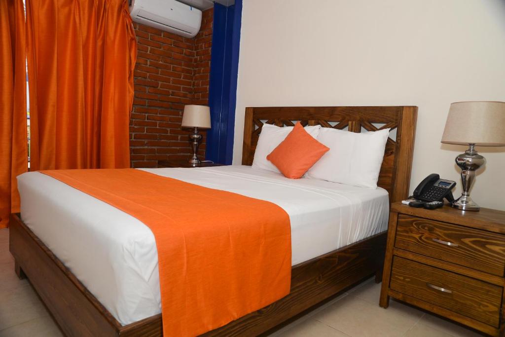 Postel nebo postele na pokoji v ubytování Hotel Jaraba
