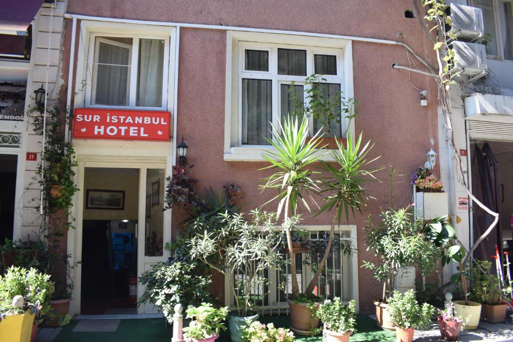 a building with potted plants in front of it at Sur Istanbul Hotel in Istanbul