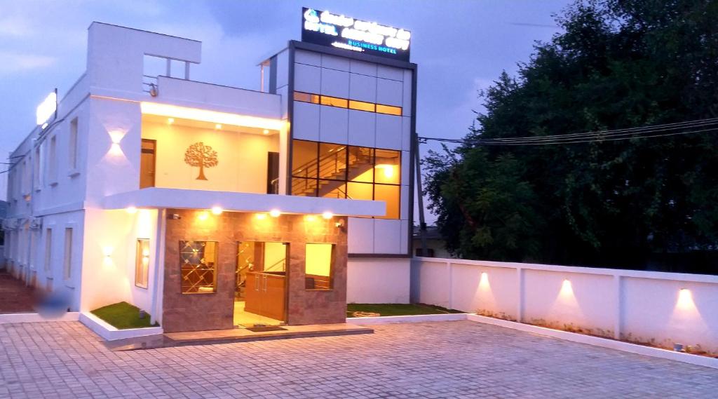 a white building with a sign on top of it at Hotel Airport City in Bangalore