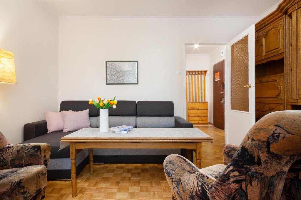 a living room with a couch and a table at Apartments Warsaw Arabska in Warsaw