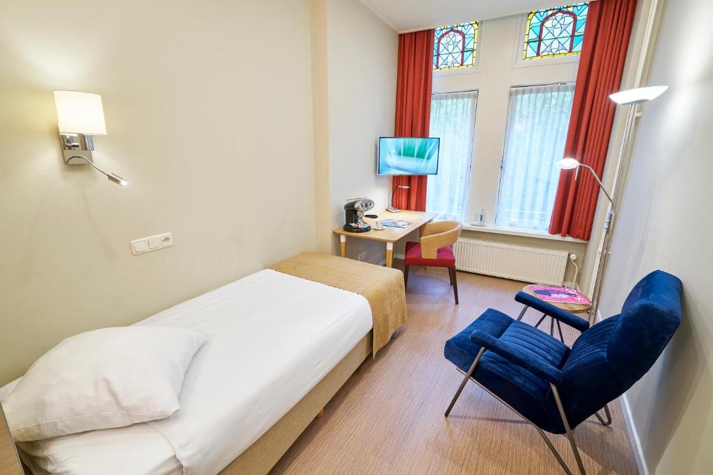 Postel nebo postele na pokoji v ubytování Hotel Van Walsum