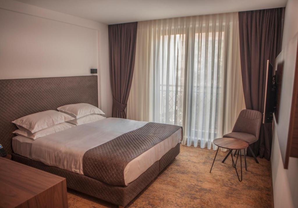 Postel nebo postele na pokoji v ubytování Qama Hotel