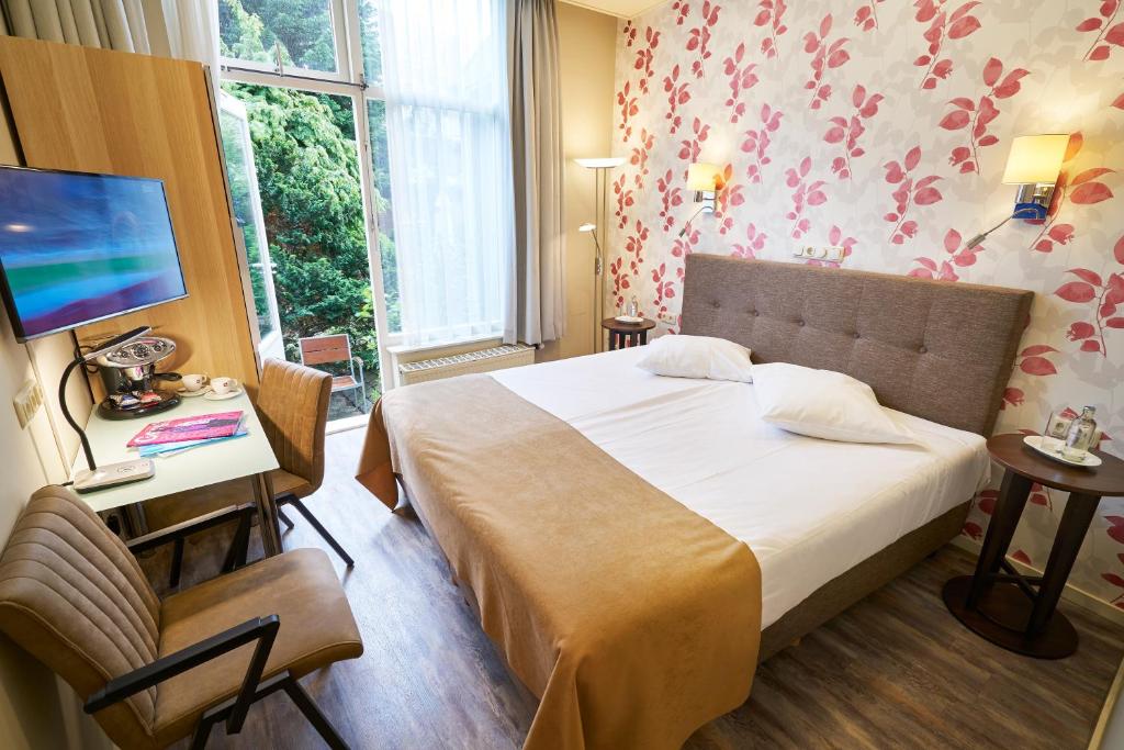 Postel nebo postele na pokoji v ubytování Hotel Van Walsum