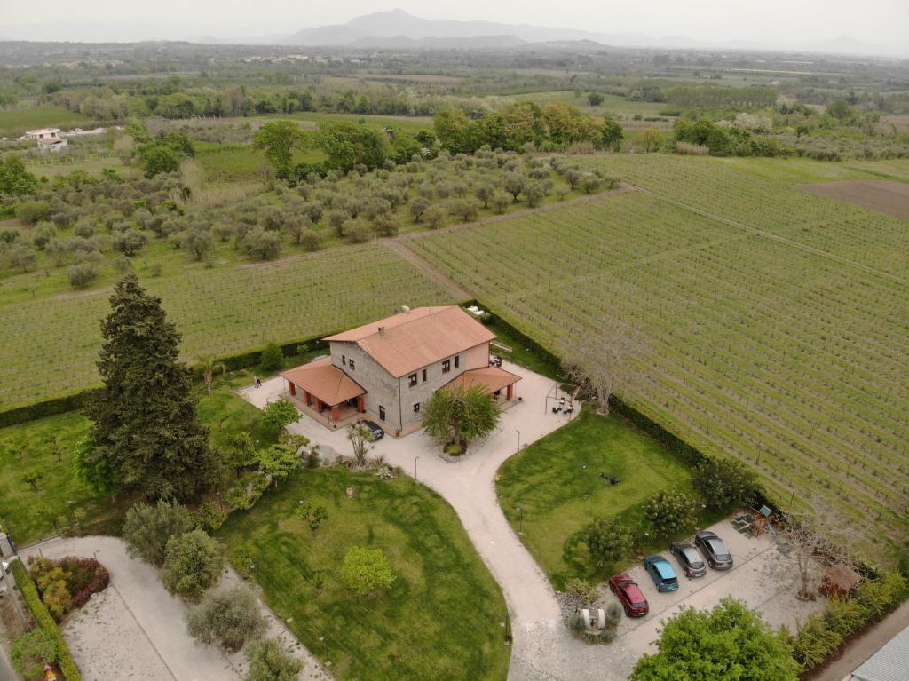 an aerial view of a house with cars parked in a field at Masseria Campierti in Falciano del Massico