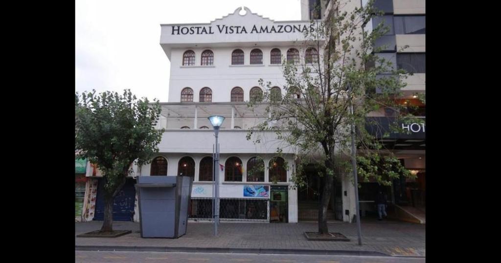 a large white building with a sign on it at HOSTAL VISTA AMAZONAS in Quito