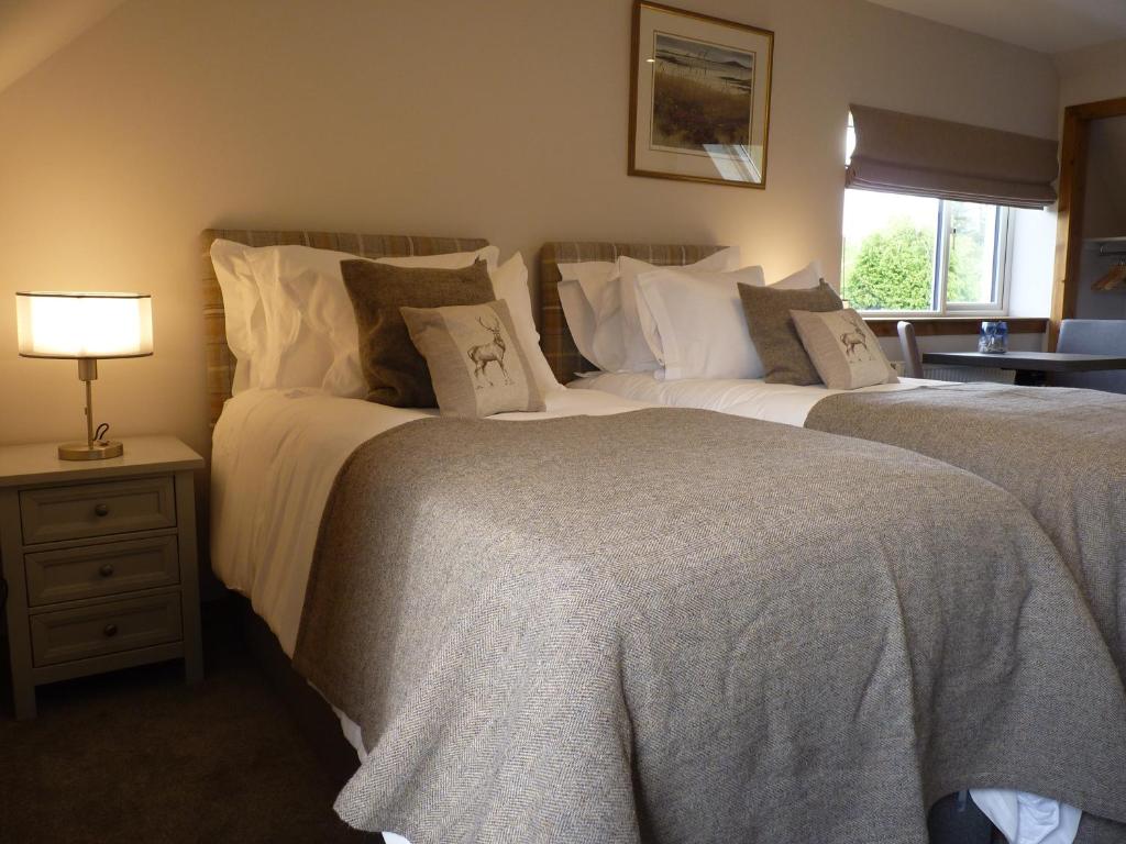 Postel nebo postele na pokoji v ubytování Skye Lodge Dunvegan Skye