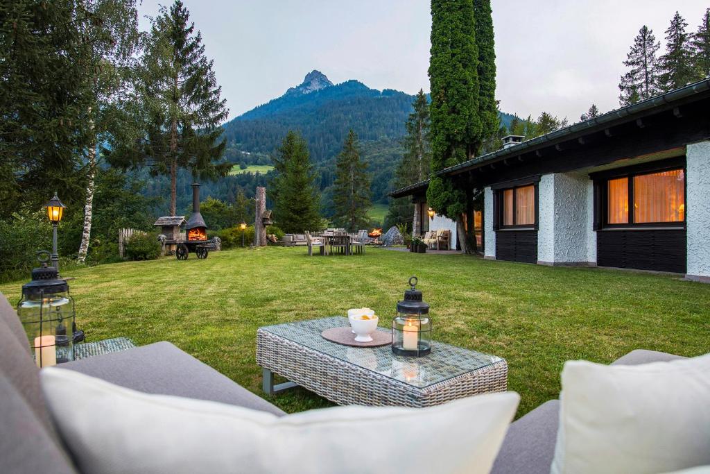a patio with a table and chairs in a yard at Chalet Waldhaus Rappakopf in Schruns