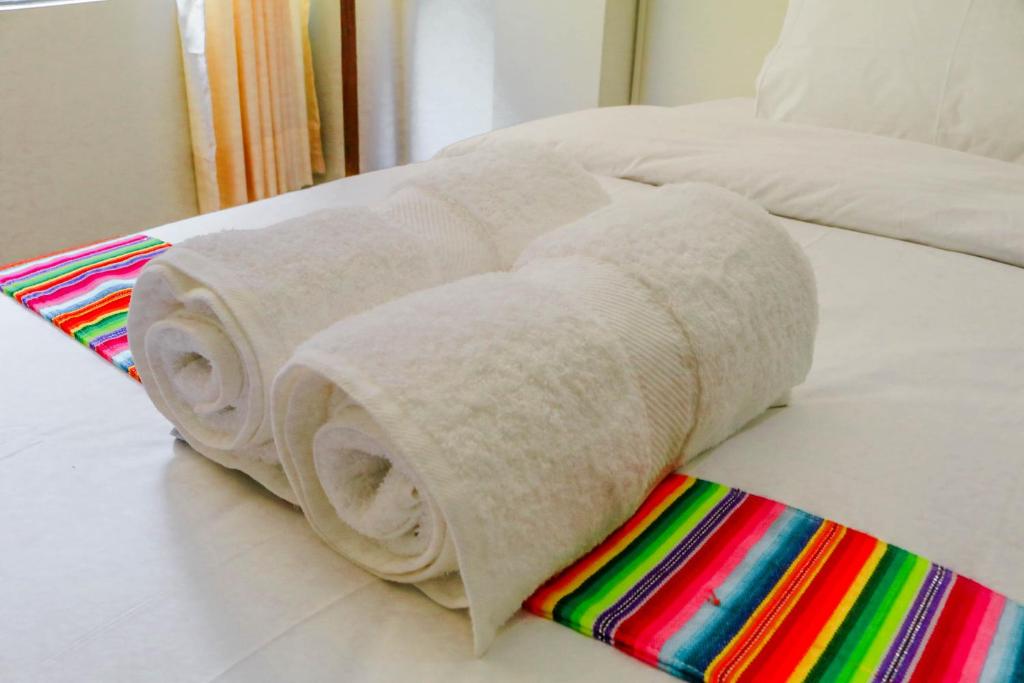 Postel nebo postele na pokoji v ubytování RUMIQOLQA Machupicchu Hotel