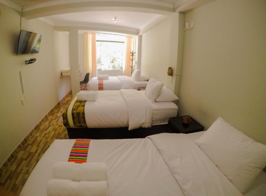 Postel nebo postele na pokoji v ubytování RUMIQOLQA Machupicchu Hotel