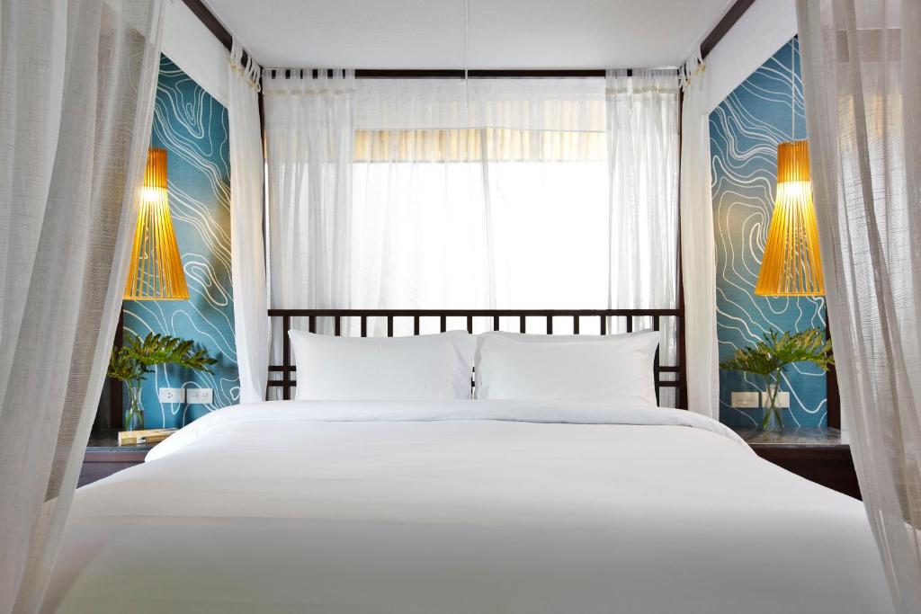 Postel nebo postele na pokoji v ubytování Sareeraya Villas & Suites