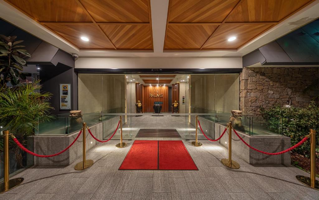 a red carpet in a hallway with a red rug at Palms Hotel in Sydney