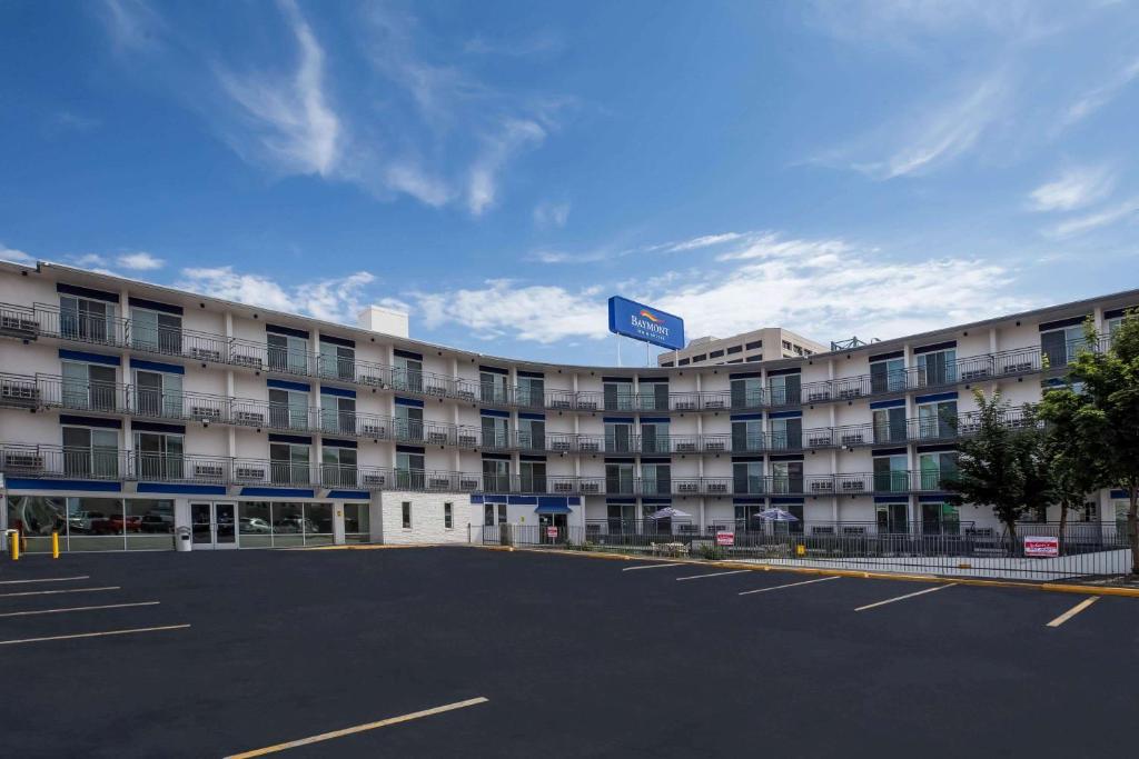 a large building with a parking lot in front of it at Baymont by Wyndham Spokane in Spokane