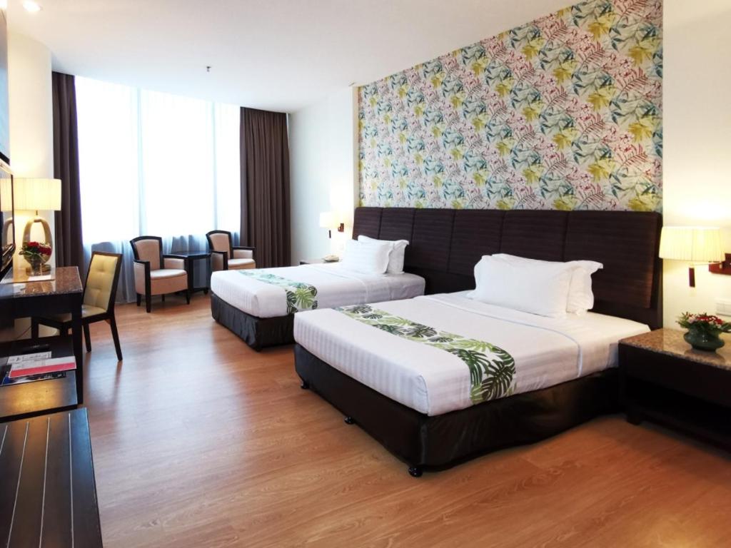 Postel nebo postele na pokoji v ubytování Grand Paragon Hotel Johor Bahru