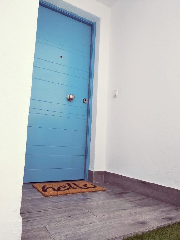 a blue door with a tiger rug in front of it at Alojamientos 4nudos in San José