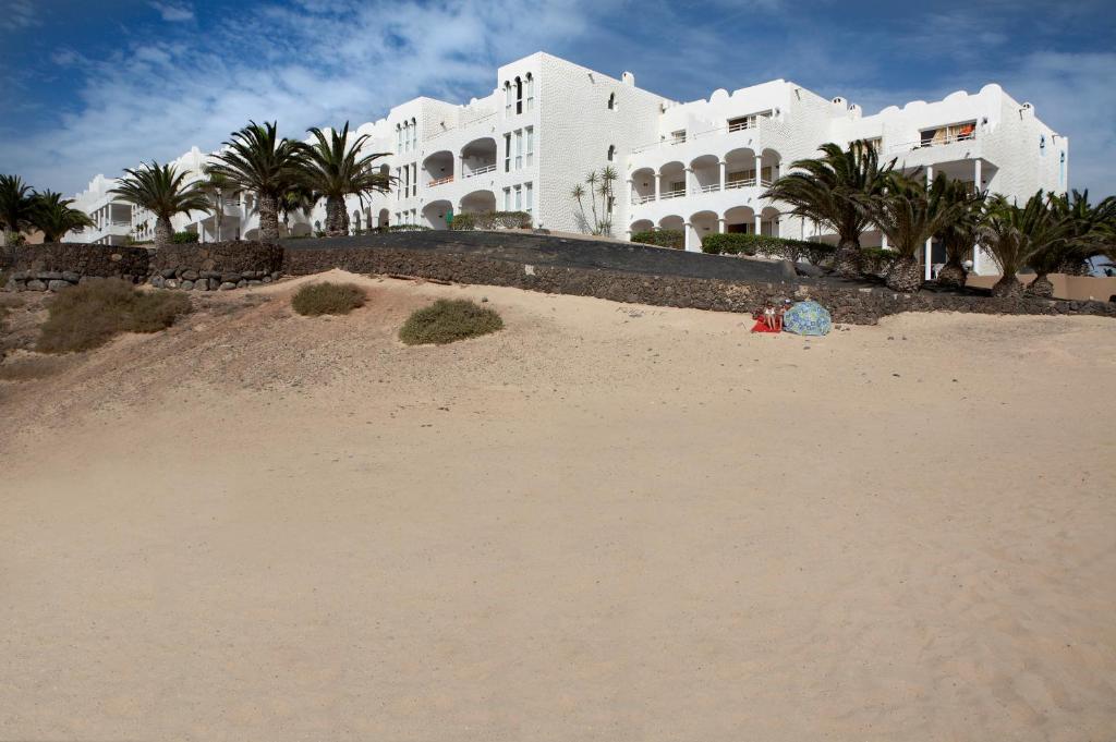 a pile of sand on the beach in front of a building at Sotavento Beach Club in Costa Calma
