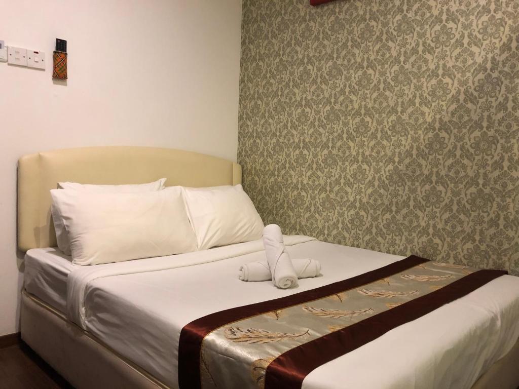 Postel nebo postele na pokoji v ubytování Woodpecker Lodge, Kuching