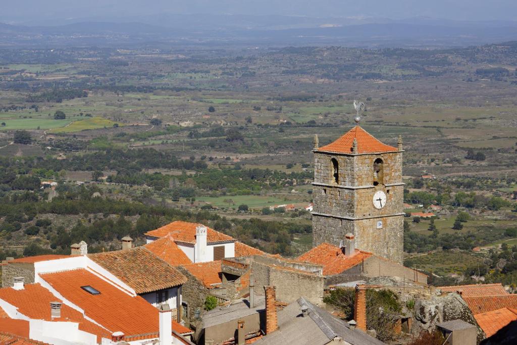 an old building with a clock tower in a village at Casas da Villa- Monsanto in Monsanto