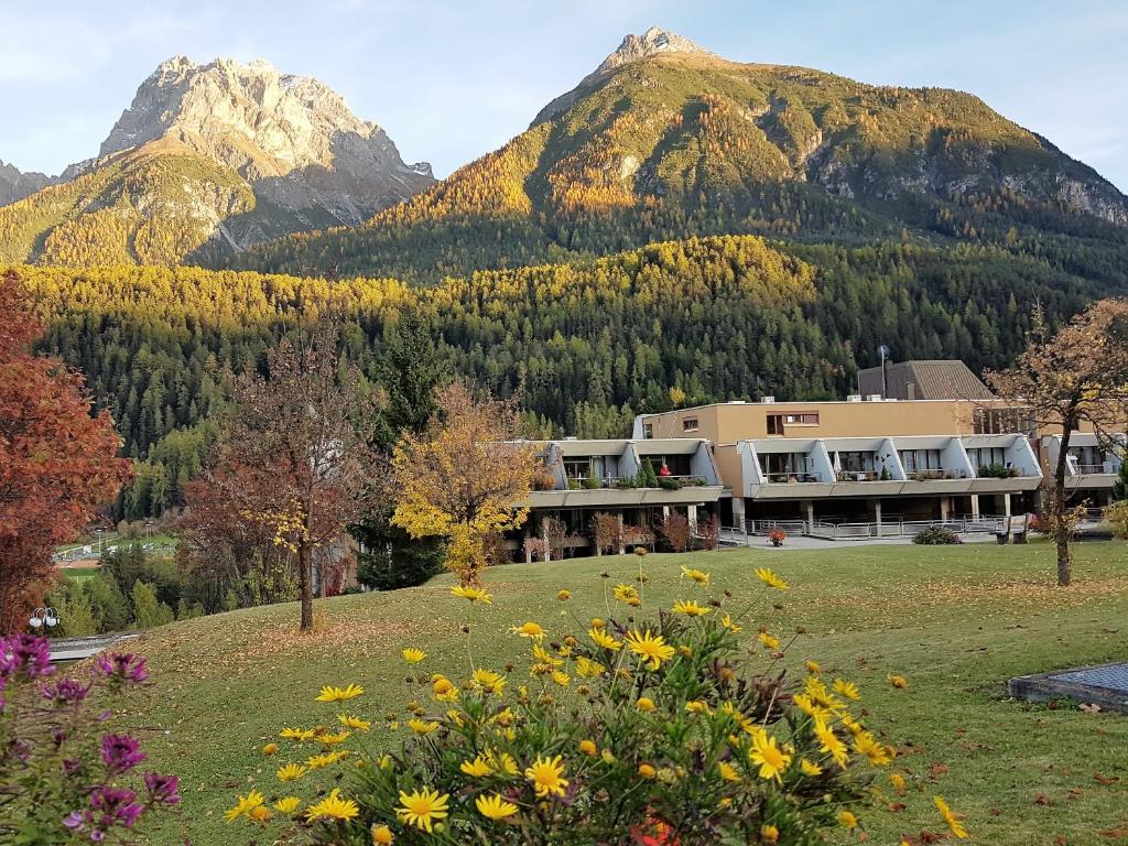 a large building in front of a mountain at Ferienpark Tulai - Fam. Carl in Scuol