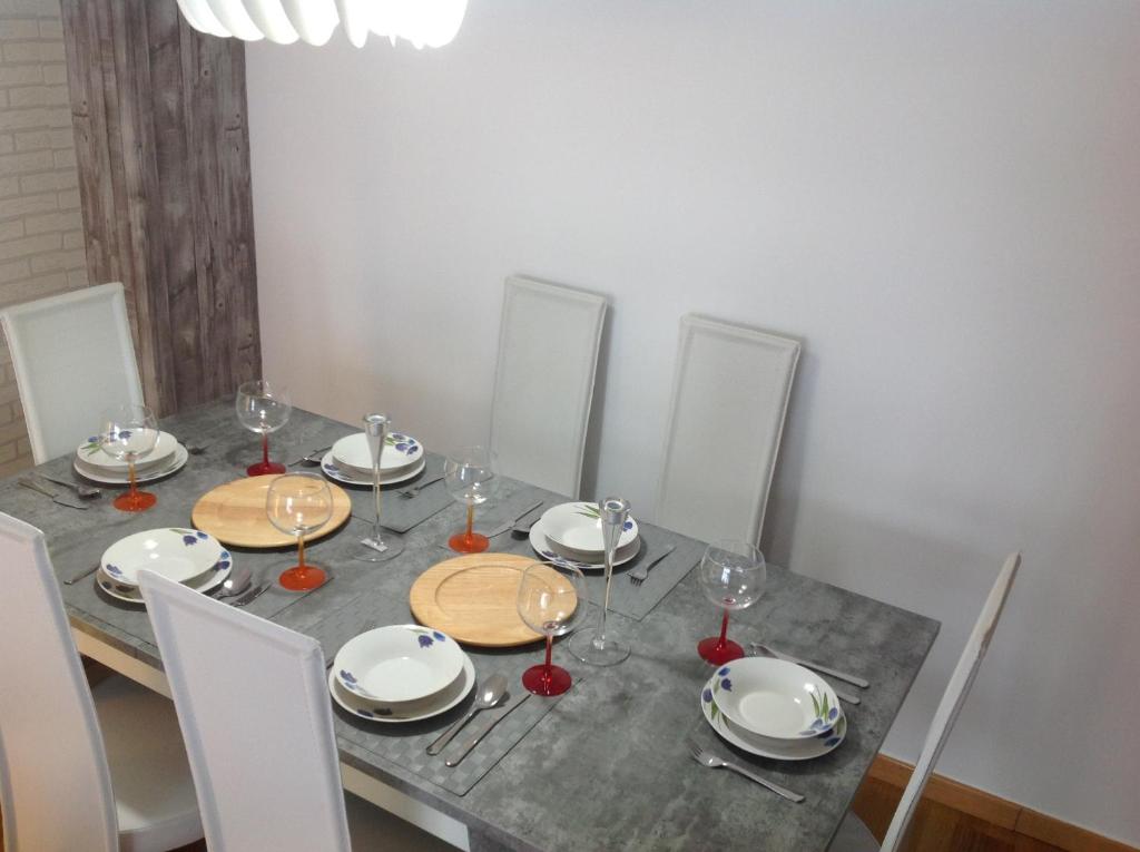 a table with plates and wine glasses on it at Nice stay in Madrid